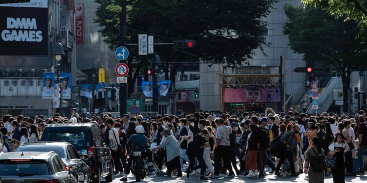 People cross an intersection in the Shibuya district of Tokyo on May 4, 2023, as visitors from across Japan and overseas pack popular tourist spots on Greenery Day, the third of four holidays which make up "Golden Week" in late April and early May. (Photo by Richard A. Brooks / AFP)