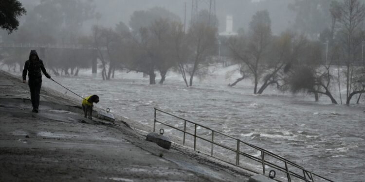 Normally at a crawl, the Los Angeles River threatens to overflow during torrential rains