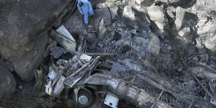 Burned bodies of Easter pilgrims still lie inside a bus that crashed off a bridge in South Africa