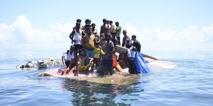 Weeping, weak and soaked, dozens of Rohingya refugees rescued after night on hull of capsized boat
